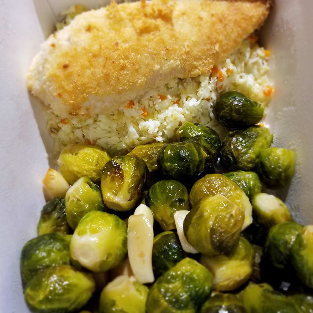 Coconut chicken with riced cauliflower roasted brussel sprouts and garlic
